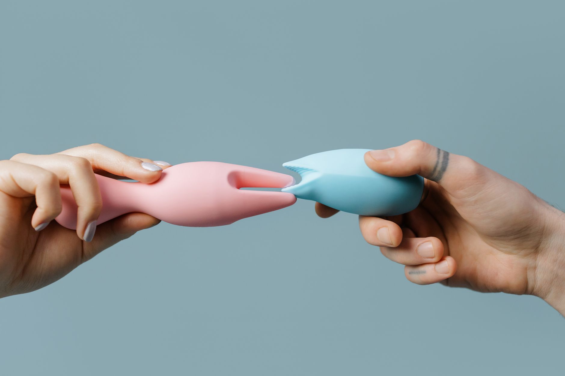 Woman holding a vibrator, contemplating the connection between sensation and emotion